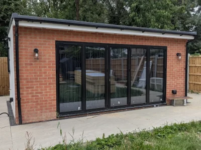 Black aluminium bifold doors installed by Durajoin
