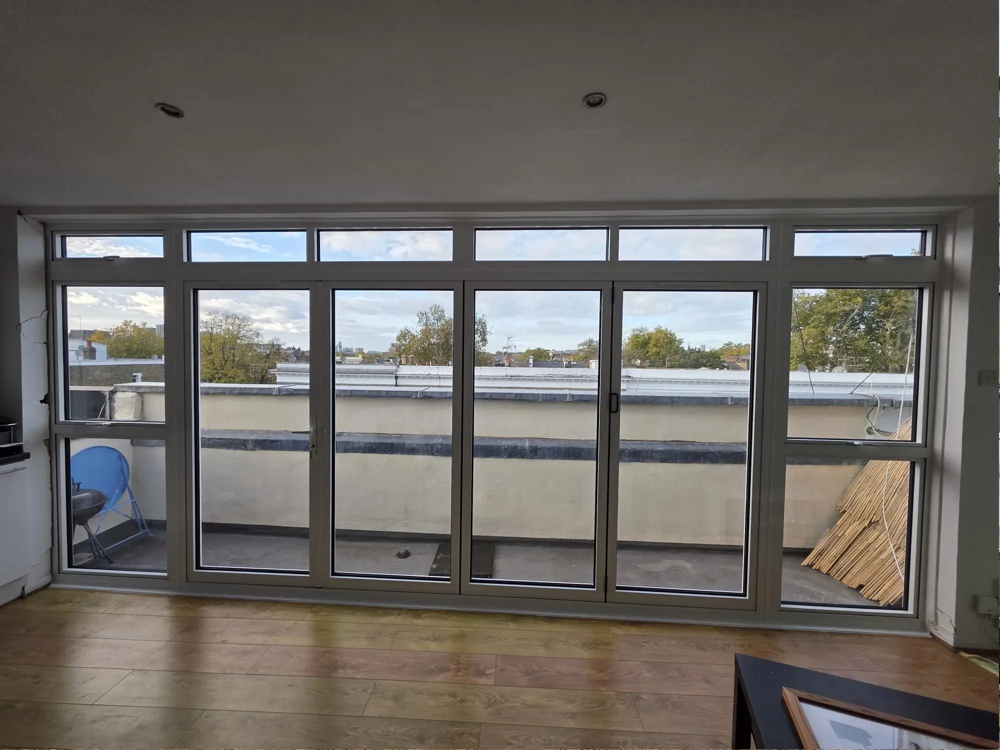 Modern white aluminium bifold doors connecting indoor and outdoor space
