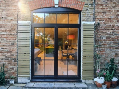 Black aluminium French doors installed at a traditional London home by Durajoin